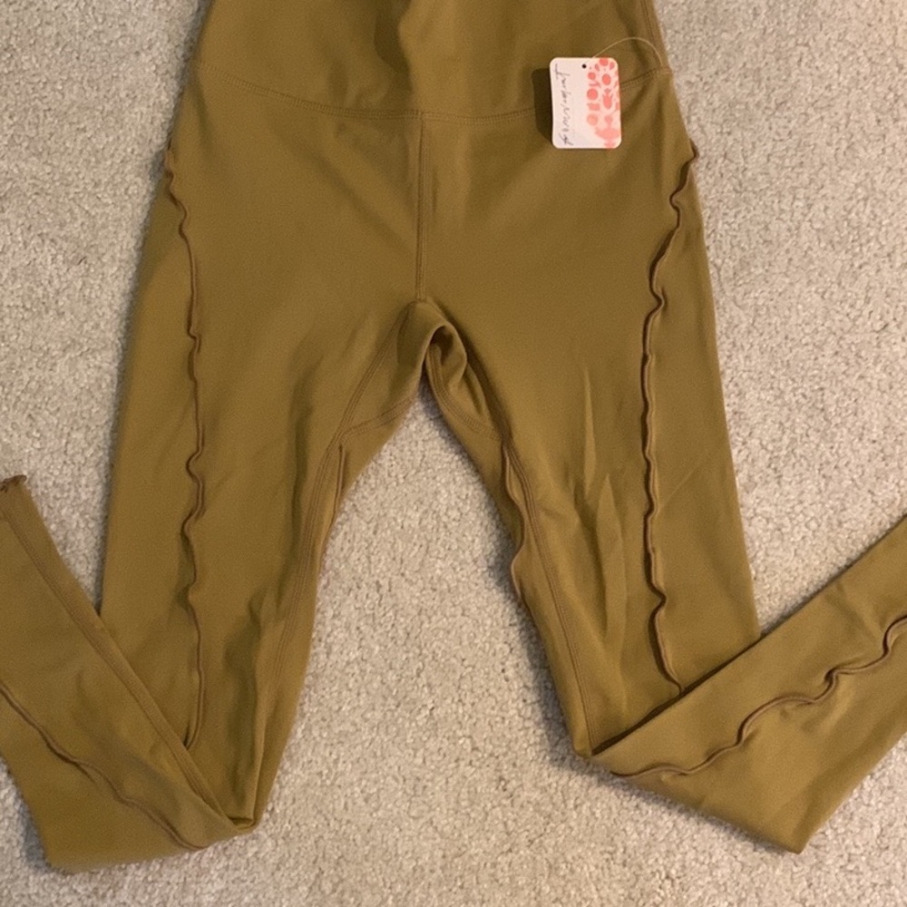 Free People Movement Golden Olive 7/8 high-rise legging. Retails for $78.